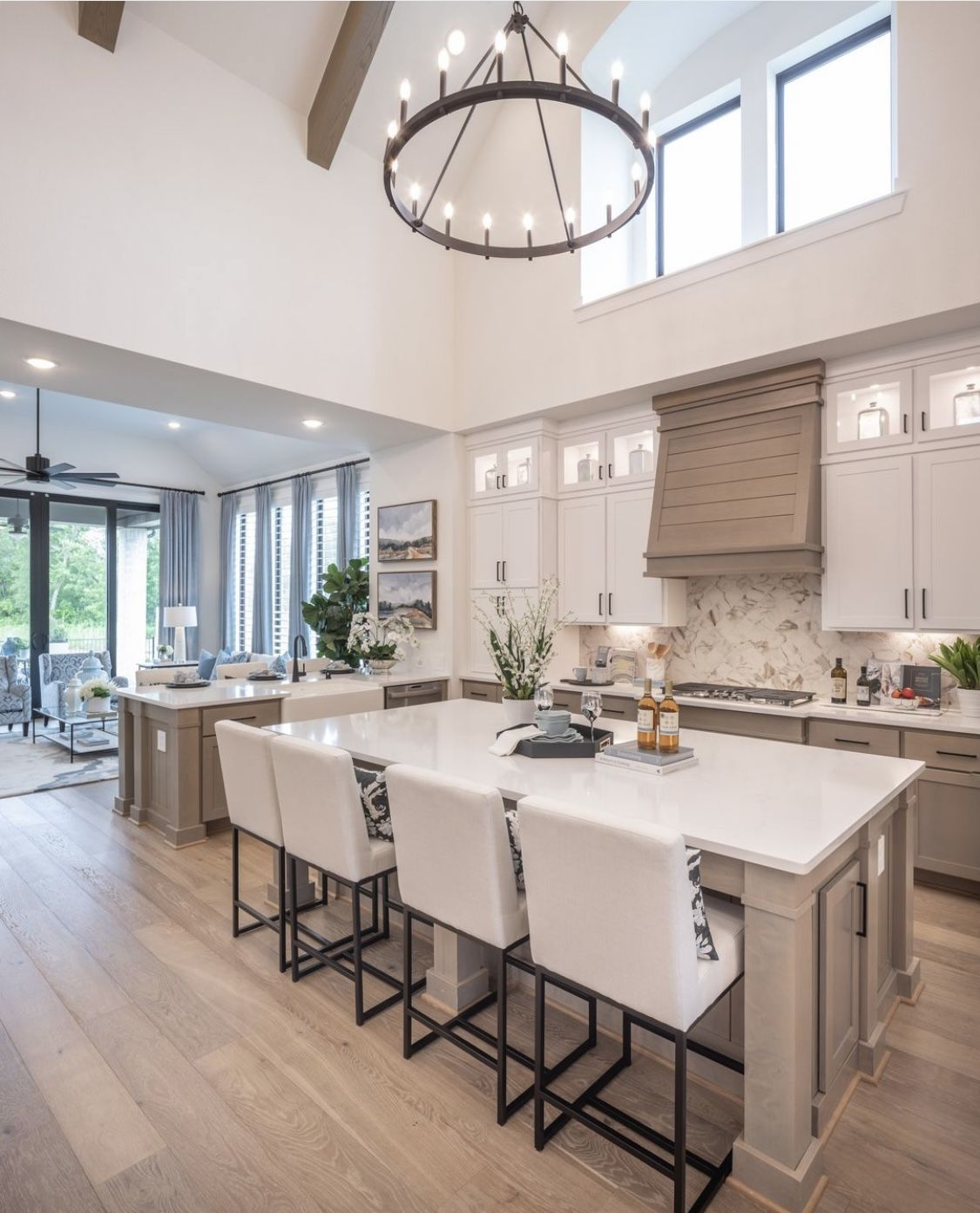 Bright open kitchen with large island and round chandelier